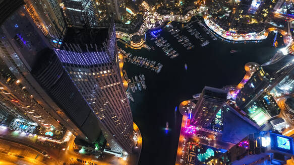 Aerial view of illuminated skyscrapers at night in Dubai, United Arab Emirates. - AAEF03258