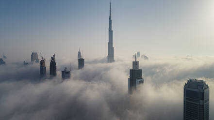 Aerial view of skyscrapers and Burj Khalifa tower in the clouds of Dubai, United Arab Emirates. - AAEF03309