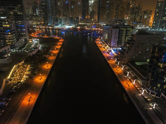 Aerial view of Dubai canal and illuminated buildings at night, United Arab Emirates. - AAEF03343