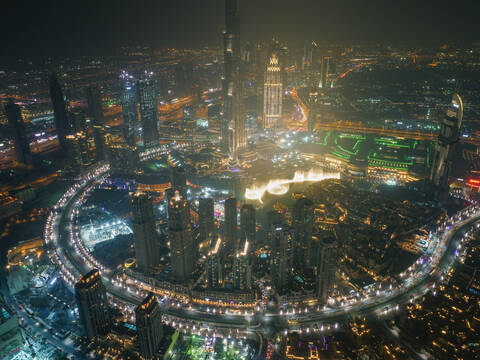 Aerial view of illuminated skyscrapers and Burj Khalifa Tower at night in Dubai, United Arab Emirates. stock photo