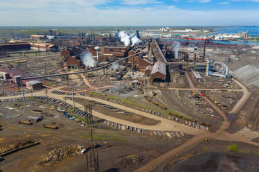 BURNS HARBOR, INDIANA, USA - MAY 14, 2019: Aerial view of a modern steel producing facility on the shores of Lake Michigan in Indiana, USA - AAEF03513