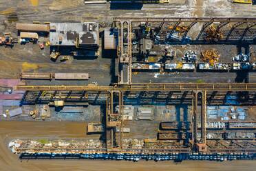 Aerial view of rail road cars, scrap metals and finished steel products at a modern steel producing facility on the shores of Lake Michigan in Indiana. - AAEF03526