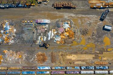 Aerial view of rail road cars, scrap metals and finished steel products at a modern steel producing facility on the shores of Lake Michigan in Indiana. - AAEF03531