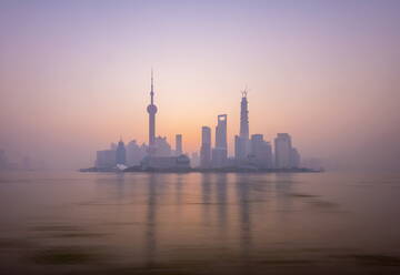 Pudong skyline across Huangpu River, including Oriental Pearl Tower, Shanghai World Financial Center, and Shanghai Tower, Shanghai, China, Asia - RHPLF01107