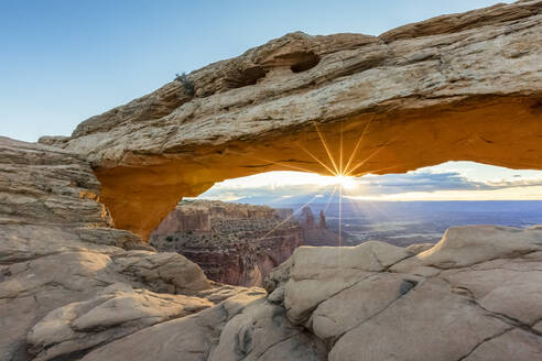 The sun is rising under Mesa Arch, Canyonlands National Park, Moab, Utah, United States of America, North America - RHPLF01256