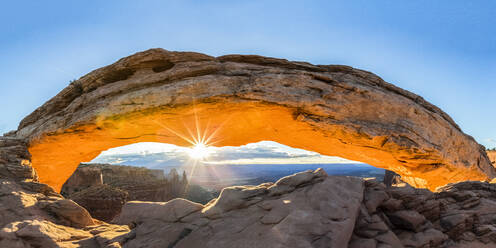 The sun rising under Mesa Arch, Canyonlands National Park, Moab, Utah, United States of America, North America - RHPLF01262