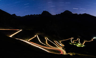 Star trail on the lights of car trace at Stelvio Pass, Valtellina, Lombardy, Trentino Alto Adige, Italy, Europe - RHPLF01412