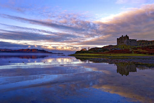 Frühmorgendlicher Blick auf Castle Tioram und Loch Moidart, als die Morgendämmerung in einen warmen, farbenfrohen Himmel einbricht und attraktive Reflexionen erzeugt, Highlands, Schottland, Vereinigtes Königreich, Europa - RHPLF01483
