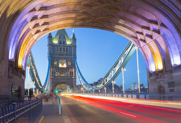 View of North Tower of Tower Bridge and car trail lights at dusk, London, England, United Kingdom, Europe - RHPLF01604