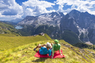 Tourists look towards Viel del Pan Refuge with Marmolada in the background, Pordoi Pass, Fassa Valley, Trentino, Dolomites, Italy, Europe - RHPLF01706