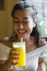 Young woman enjoying a smoothie - MGIF00679