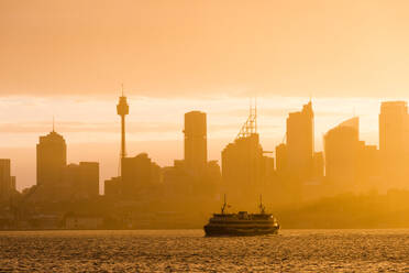 Sydney city skyline looking towards the sun with ferry, Sydney, New South Wales, Australia, Pacific - RHPLF01915