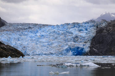 Ice pack and blue ice face of South Sawyer Glacier, mountain backdrop, Stikine Icefield, Tracy Arm Fjord, Alaska, United States of America, North America - RHPLF02234