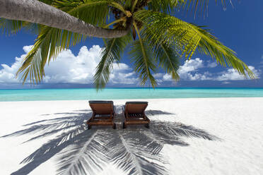 Two deck chairs under palm trees and tropical beach, The Maldives, Indian Ocean, Asia - RHPLF02363