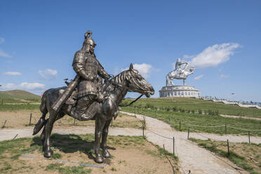 Statue of a Mongolian Empire warrior and Genghis Khan Statue Complex in the background, Erdene, Tov province, Mongolia, Central Asia, Asia - RHPLF02778