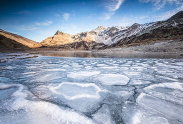 Frozen lake Montespluga at dawn, Chiavenna Valley, Sondrio province, Valtellina, Lombardy, Italy, Europe - RHPLF02906