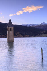 Sunset from the famous bell tower of Curon Venosta, Resia Pass, South Tyrol, Italy, Europe - RHPLF03169