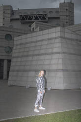 Girl in silver suit standing in futuristic city - VPIF01400