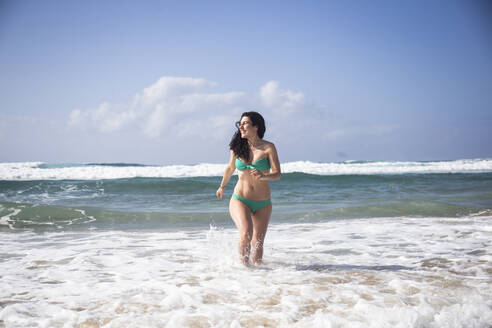 Happy woman at seaside, Fuerteventura, Spain - ABZF02521