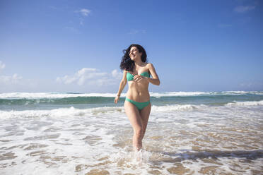 Happy woman at seaside, Fuerteventura, Spain - ABZF02522