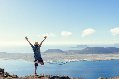 Man on viewpoint looking to La Gracioas island from Lanzarote, Canary Islands, Spain - KIJF02635