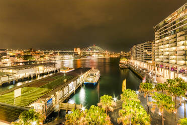 Illuminated Circular Quay against sky at night in Sydney, Australia - SMAF01328