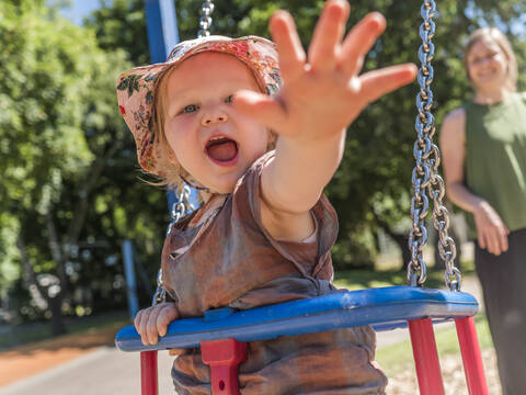 Portrait of happy little girl with her mother on playground stock photo