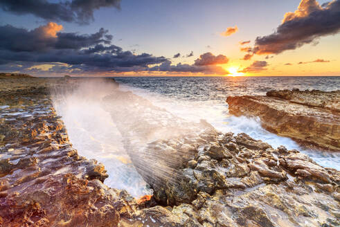 Wellen brechen an Klippen bei Sonnenaufgang, Devil's Bridge, Antigua, Antigua und Barbuda, Leeward-Inseln, Westindien, Karibik, Mittelamerika - RHPLF03513