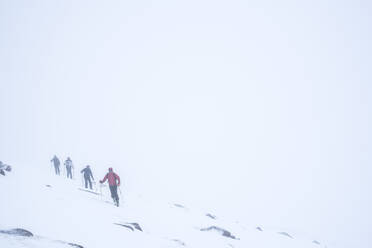 Ski touring in a snow blizzard white out at CairnGorm Mountain Ski Resort, Cairngorms National Park, Scotland, United Kingdom, Europe - RHPLF03688