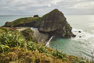 Das Surferparadies und der schwarze Vulkansandstrand von Piha mit dem Lion Rock, einem Monolithen mit vielen Maori-Schnitzereien, Region Auckland, Nordinsel, Neuseeland, Pazifik - RHPLF04213