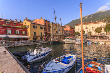 View of boats in Malcesine Harbour by the Lake, Malcesine, Lake Garda, Veneto, Italian Lakes, Italy, Europe - RHPLF04257