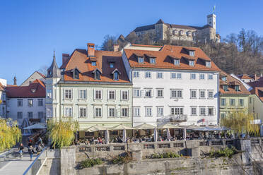 Blick auf Gebäude entlang des Flusses Ljubljanica und die Burg im Hintergrund, Ljubljana, Slowenien, Europa - RHPLF04278