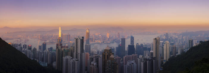 Hong Kong skyline at sunset, with a beautiful view of the Central CBD, Victoria Harbour, Kowloon cityscape, Hong Kong, China, Asia - RHPLF04521