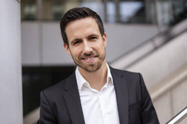 Portrait of smiling businessman in the city - DIGF08083