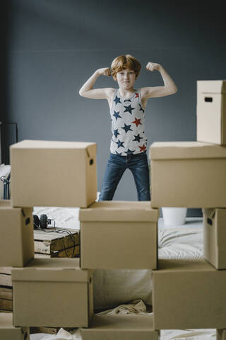 Portrait of boy flexing muscles stock photo