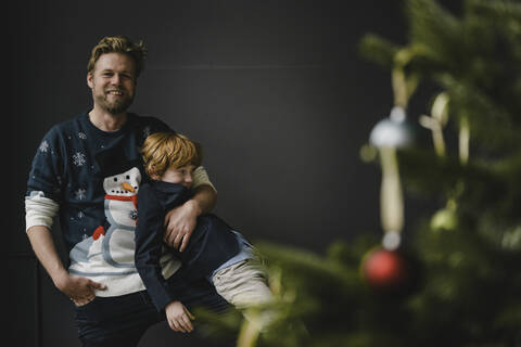 Father and son having fun together at Christmas time stock photo