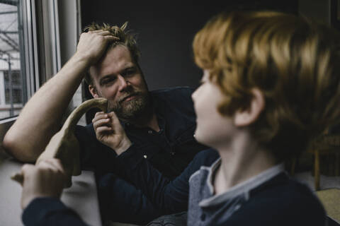 Portrait of father watching his son stock photo
