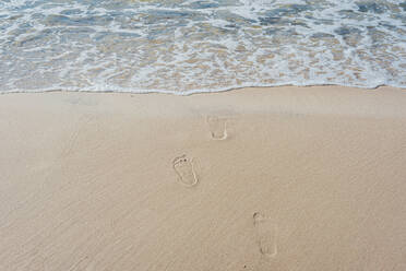 High angle view of footprints on sea shore at beach in Poland - MJF02419