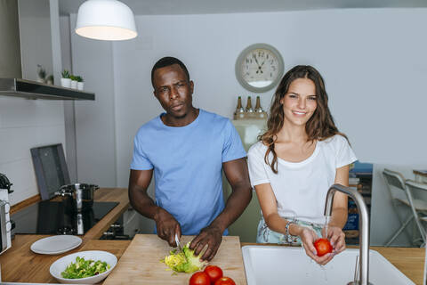 Couple preparing salad in kitchen stock photo