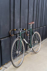 Racing bicycle leaning against a wall - AFVF03869