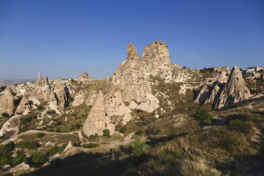 Uchisar castle against clear blue sky at Cappadocia, Turkey - KNTF03132