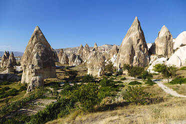 Scenic view of Dove complex monastery against clear blue sky, Cappadocia, Turkey - KNTF03205