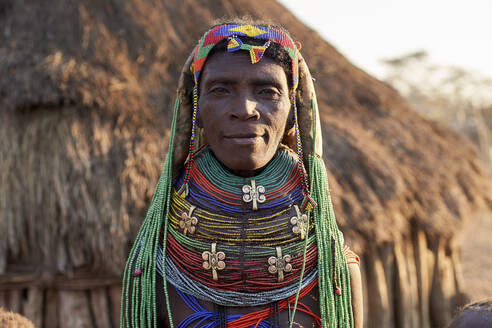 Muhila woman with her characteristic hairstyle and necklaces, Kehamba, Chibia, Angola. - VEGF00540