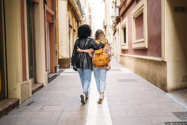 Rear view of multicultural women walking in the city, Almeria, Spain - MPPF00004