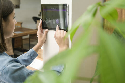 Young woman with tablet with smart home control functions - UUF18844