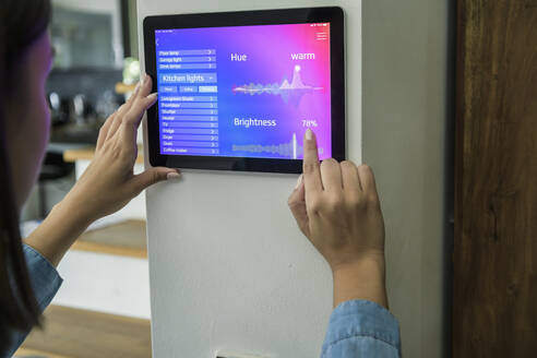 Young woman with tablet with smart home control functions - UUF18846