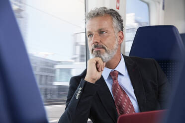 Mature businessman traveling by train - FKF03587