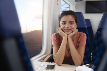 Portrait of eenage girl traveling alone by train - FKF03601