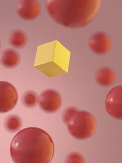 Rendering of yellow cube amidst red spheres - AHUF00568