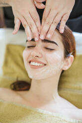 Young woman receiving facial beauty treatment in a spa - LJF00853